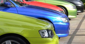 Multiple cars lined up on a used car lot.